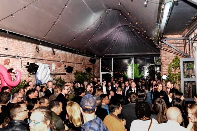 image of outdoor party with crowd of people under twinkling lights