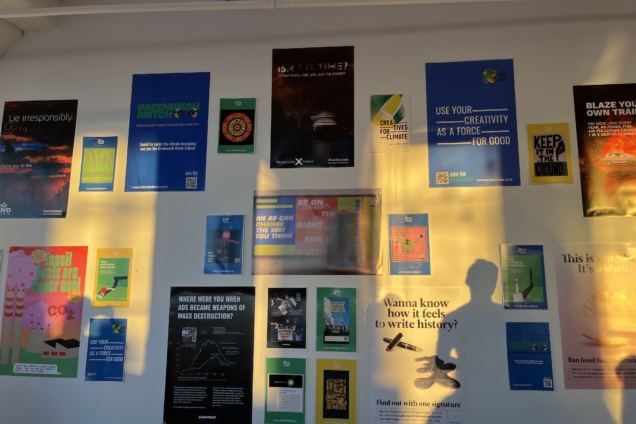 Several colorful posters decorate a white wall.