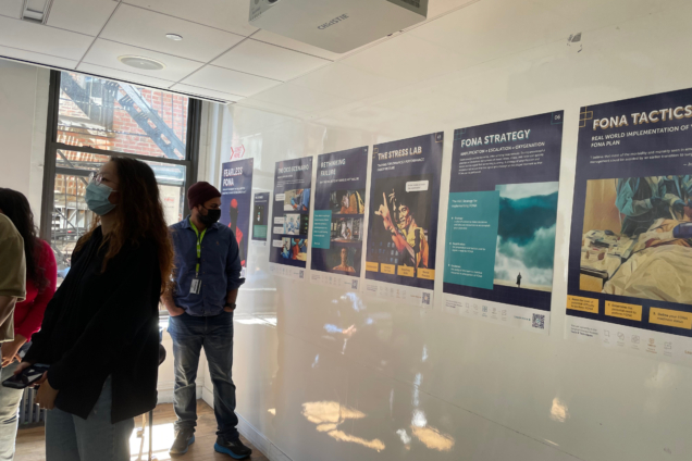 DSI Students Presenting mock ups of posters on the wall