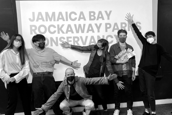 Students with Jamaica Bay Rockaway Parks Conservancy team in front of a screen