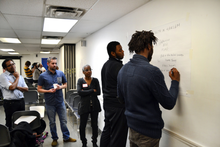 Four people mapping on a whiteboard