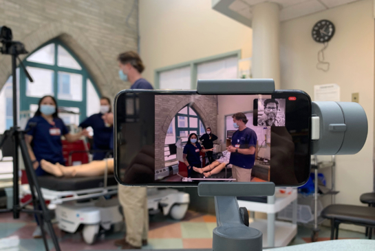 Smartphone in a hospital demonstration clinic recording a medical education telesimulation